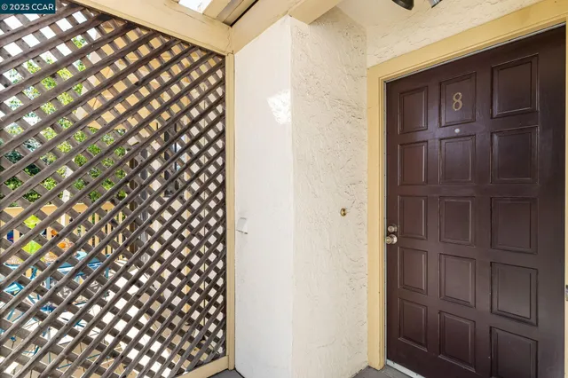 a living room with furniture a rug and a floor to ceiling window