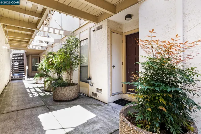 a living room with furniture a fireplace and wooden floor