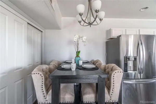 a dining room with furniture and chandelier