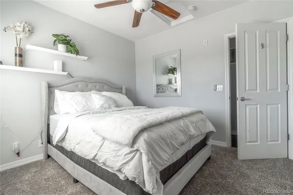a bedroom with a bed table and a window