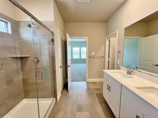 a spacious bathroom with a shower and a sink