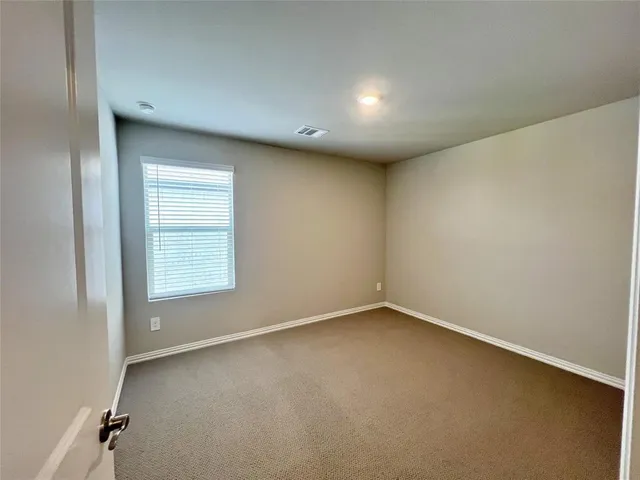 an empty room with a empty space and windows