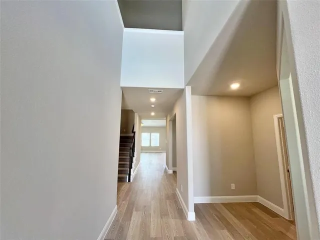 a view of hallway with wooden floor