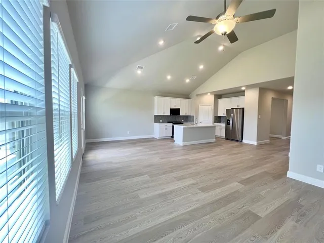 a view of a kitchen with a sink and a refrigerator