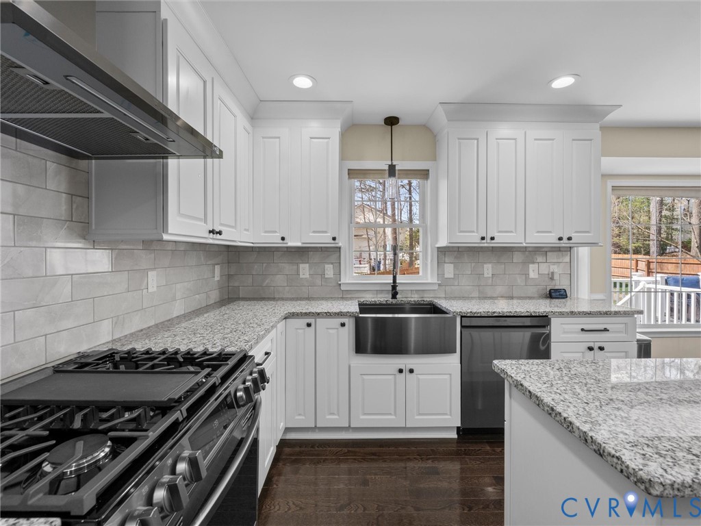 14012 Lippingham Terrace Chester, VA 23831 - Photo 13 of 50 a kitchen with stainless steel appliances granite countertop a sink stove and cabinets