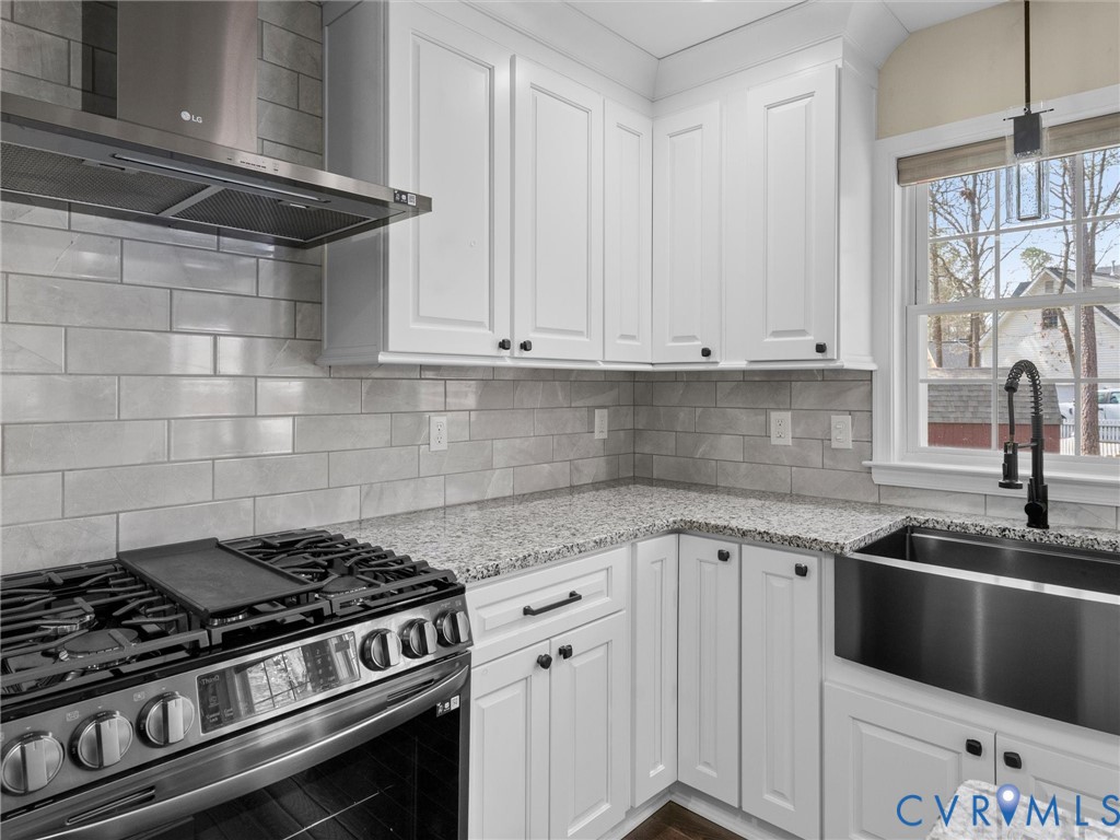 14012 Lippingham Terrace Chester, VA 23831 - Photo 15 of 50 a kitchen with granite countertop a stove sink and cabinets