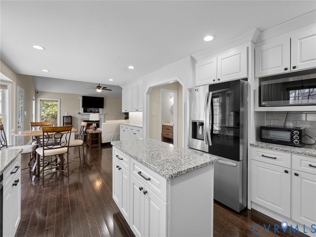 14012 Lippingham Terrace Chester, VA 23831 - Photo 17 of 50 a kitchen with granite countertop kitchen island wooden cabinets and stainless steel appliances