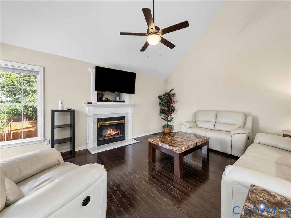 14012 Lippingham Terrace Chester, VA 23831 - Photo 21 of 50 a living room with furniture a flat screen tv and a fireplace