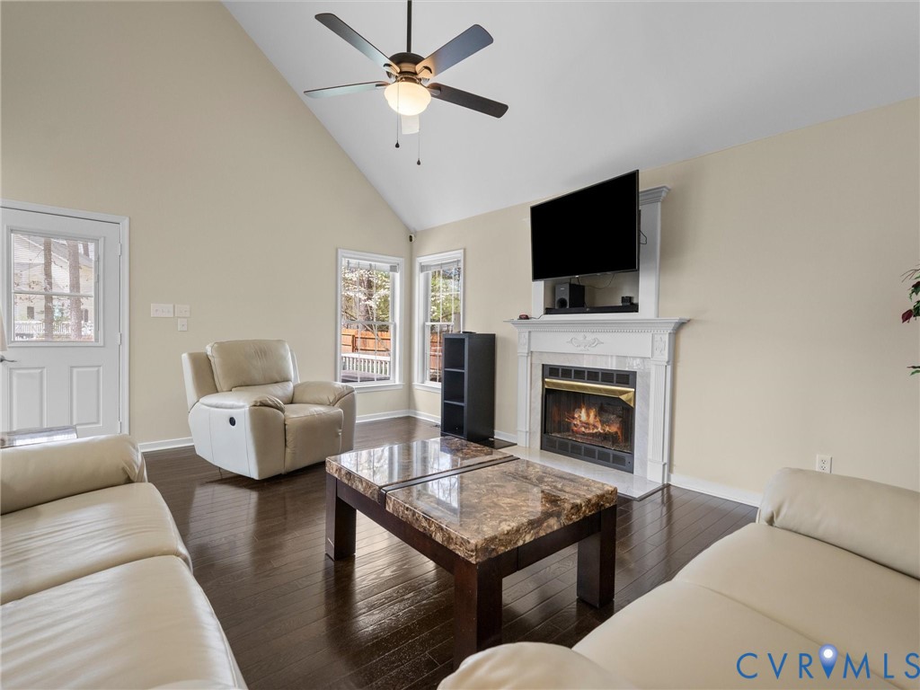 14012 Lippingham Terrace Chester, VA 23831 - Photo 22 of 50 a living room with furniture a flat screen tv and a fireplace