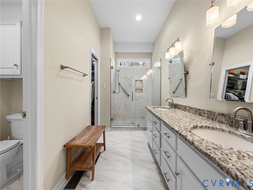 14012 Lippingham Terrace Chester, VA 23831 - Photo 26 of 50 a spacious bathroom with a granite countertop sink a toilet a mirror and shower