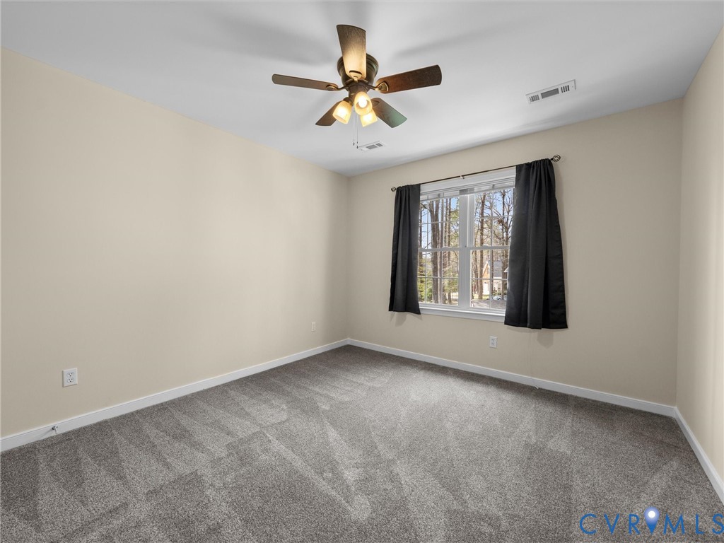 14012 Lippingham Terrace Chester, VA 23831 - Photo 31 of 50 an empty room with chandelier fan and windows