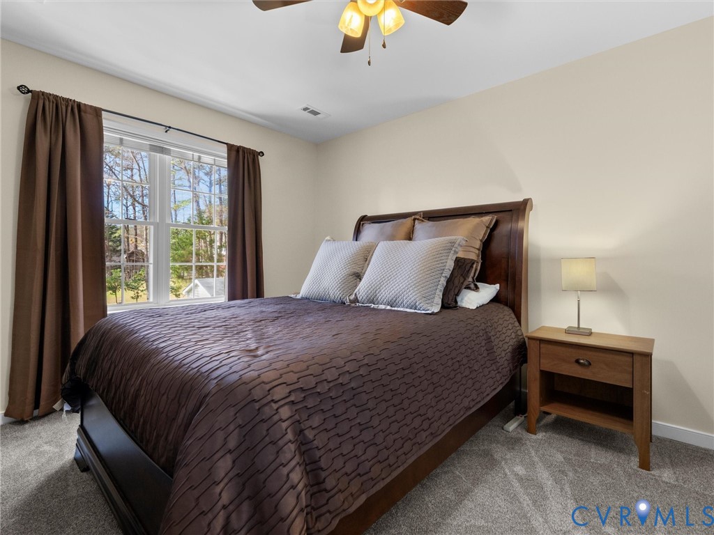 14012 Lippingham Terrace Chester, VA 23831 - Photo 33 of 50 a large bed sitting in a bedroom next to a window
