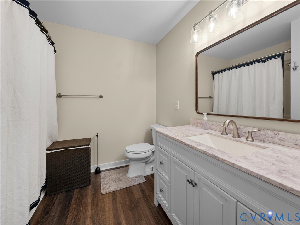 14012 Lippingham Terrace Chester, VA 23831 - Photo 37 of 50 a bathroom with a granite countertop toilet sink and mirror