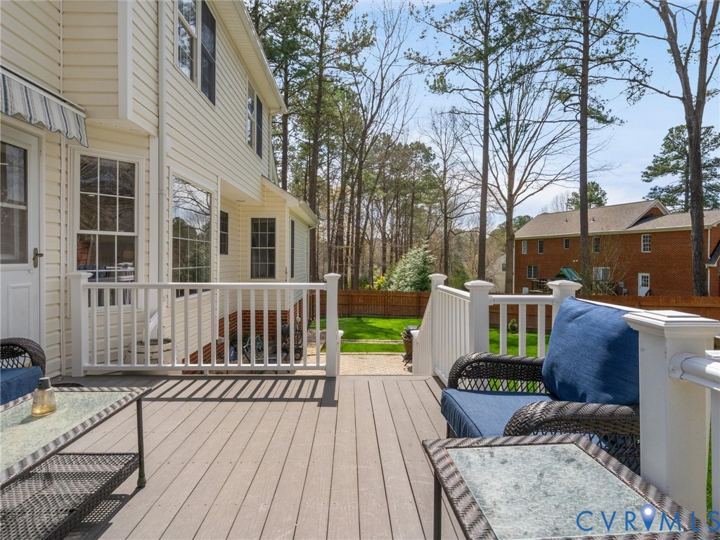 14012 Lippingham Terrace Chester, VA 23831 - Photo 39 of 50 a view of a deck with couches table and chairs with wooden floor and fence