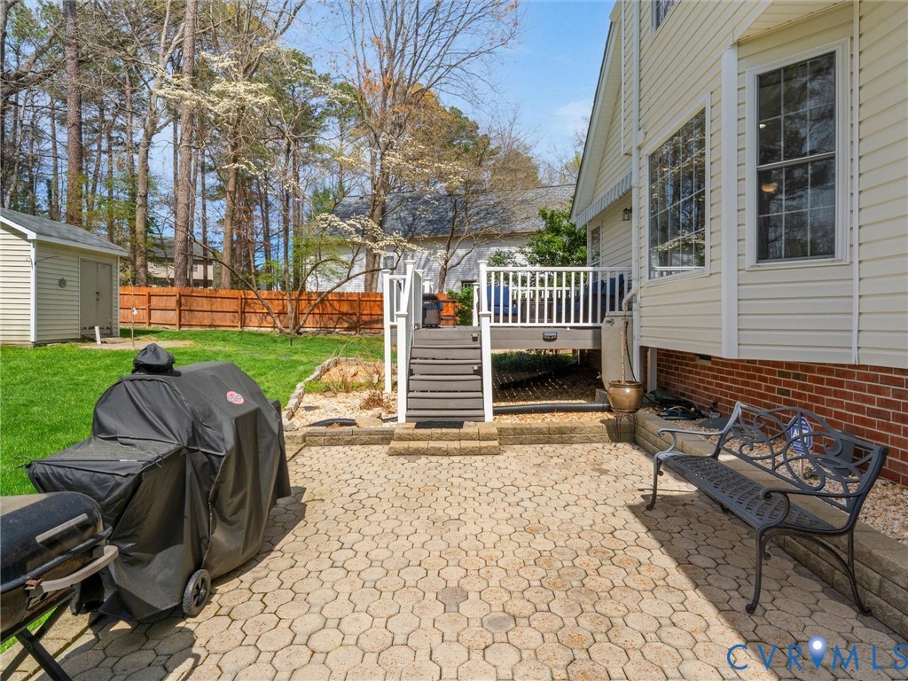 14012 Lippingham Terrace Chester, VA 23831 - Photo 42 of 50 a view of a patio with table and chairs with wooden fence and plants