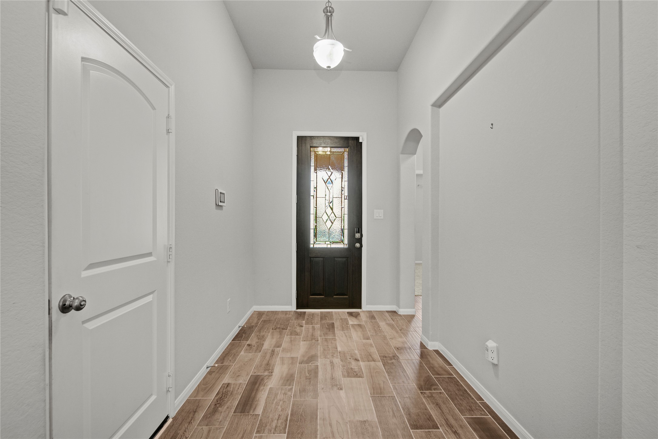 1314 Orchard Ridge Lane Tomball, TX 77375 - Photo 6 of 35 The foyer features wood-look tile flooring and a clean, functional layout with convenient access to the garage.