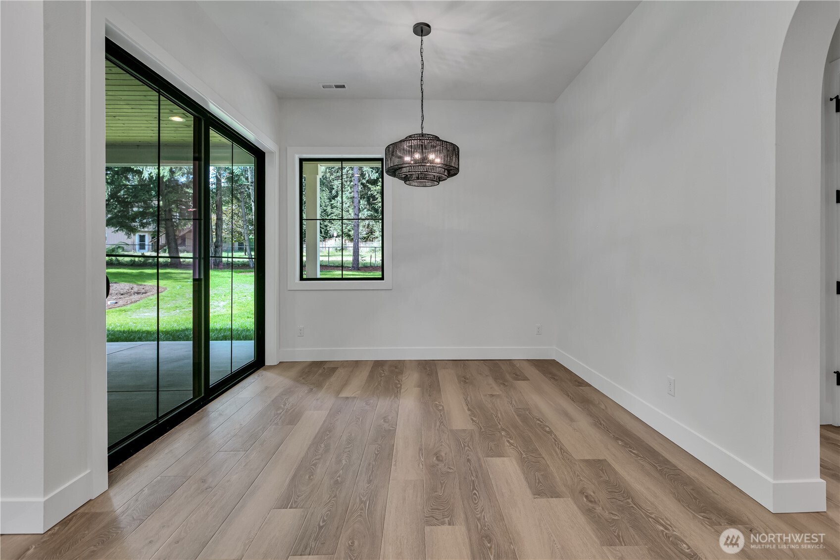 6709 254th Street East Graham, WA 98338 - Photo 15 of 40 a view of an empty room with wooden floor and a window