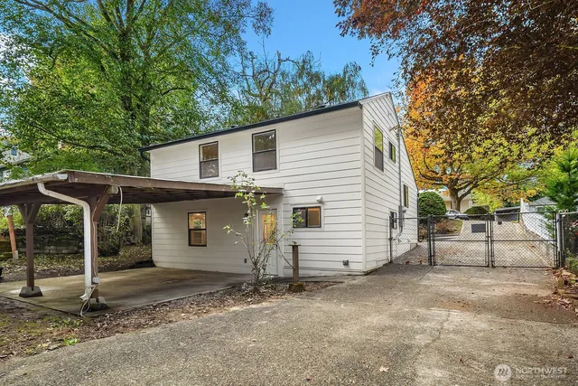 a view of a house with a backyard