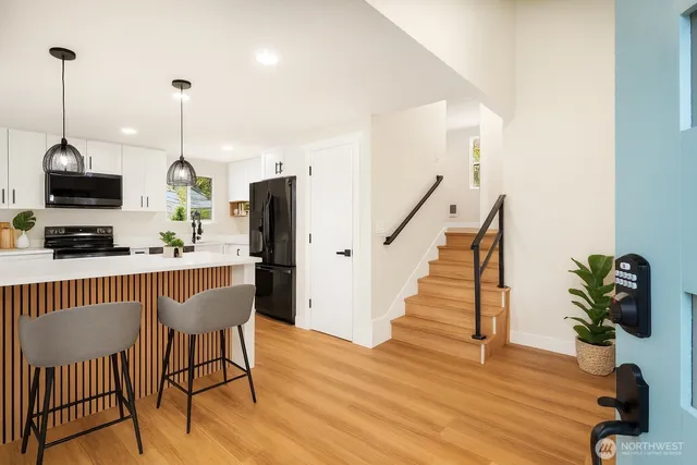 a view of a dining room with furniture wooden floor and a chandelier