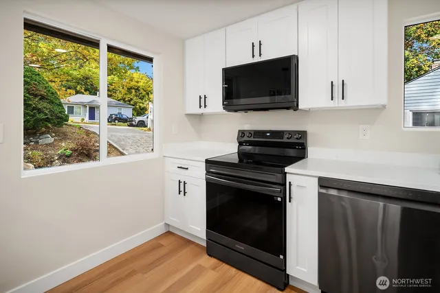 a kitchen with a stove and a microwave