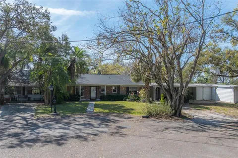 a view of a house with a tree in front