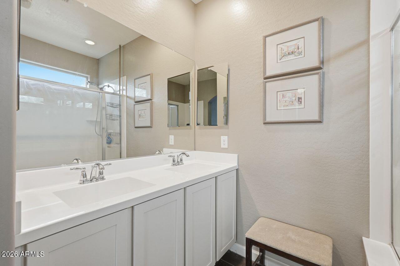 23602 West Ripple Road Buckeye, AZ 85326 - Photo 25 of 38 a bathroom with a sink and a mirror