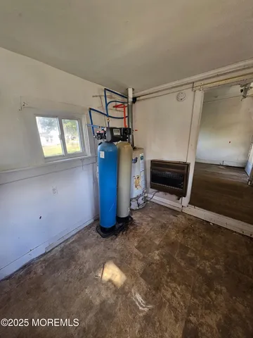 a view of storage and utility room with window