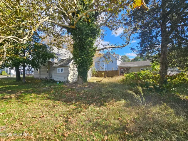 a view of backyard of house with green space