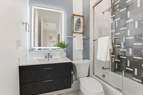 an outdoor living room with patio furniture and a potted plant