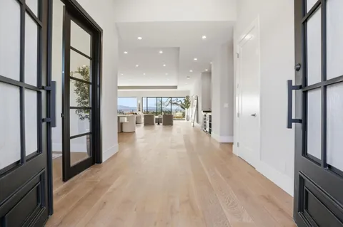 a living room with fireplace furniture and a large window