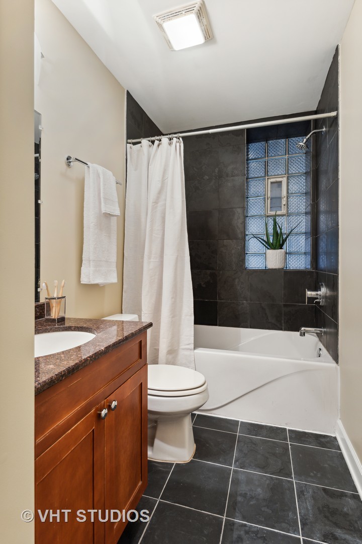 1902 West Byron Street, Unit 2 Chicago, IL 60613 - Photo 13 of 17 a bathroom with a sink a toilet and shower