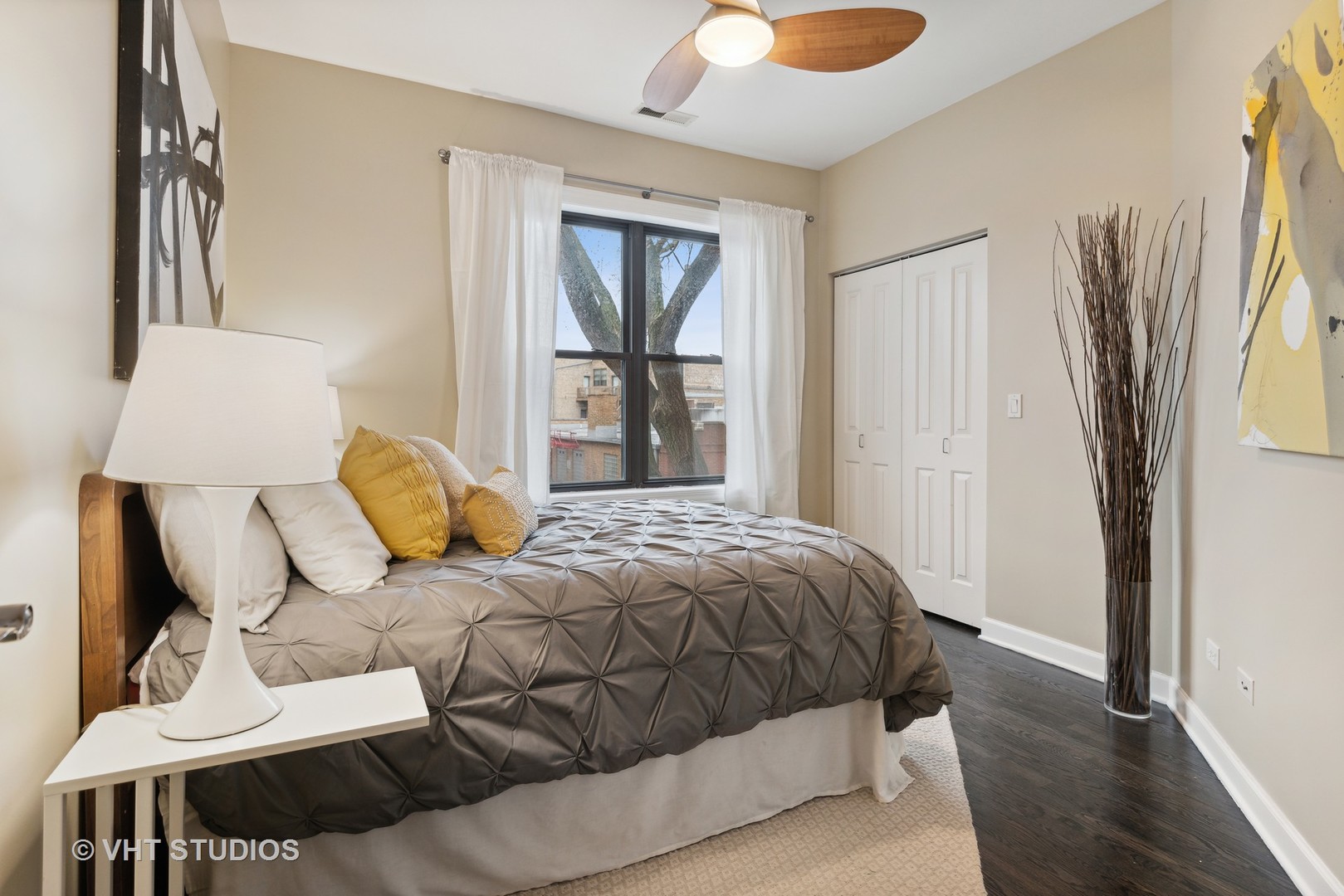 1902 West Byron Street, Unit 2 Chicago, IL 60613 - Photo 3 of 17 a bedroom with a bed and wooden floor