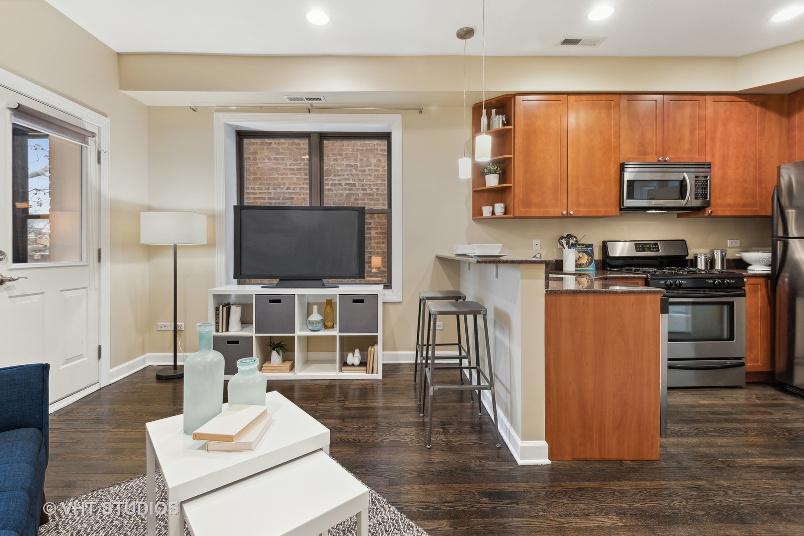 1902 West Byron Street, Unit 2 Chicago, IL 60613 - Photo 4 of 17 a living room with stainless steel appliances furniture and a flat screen tv