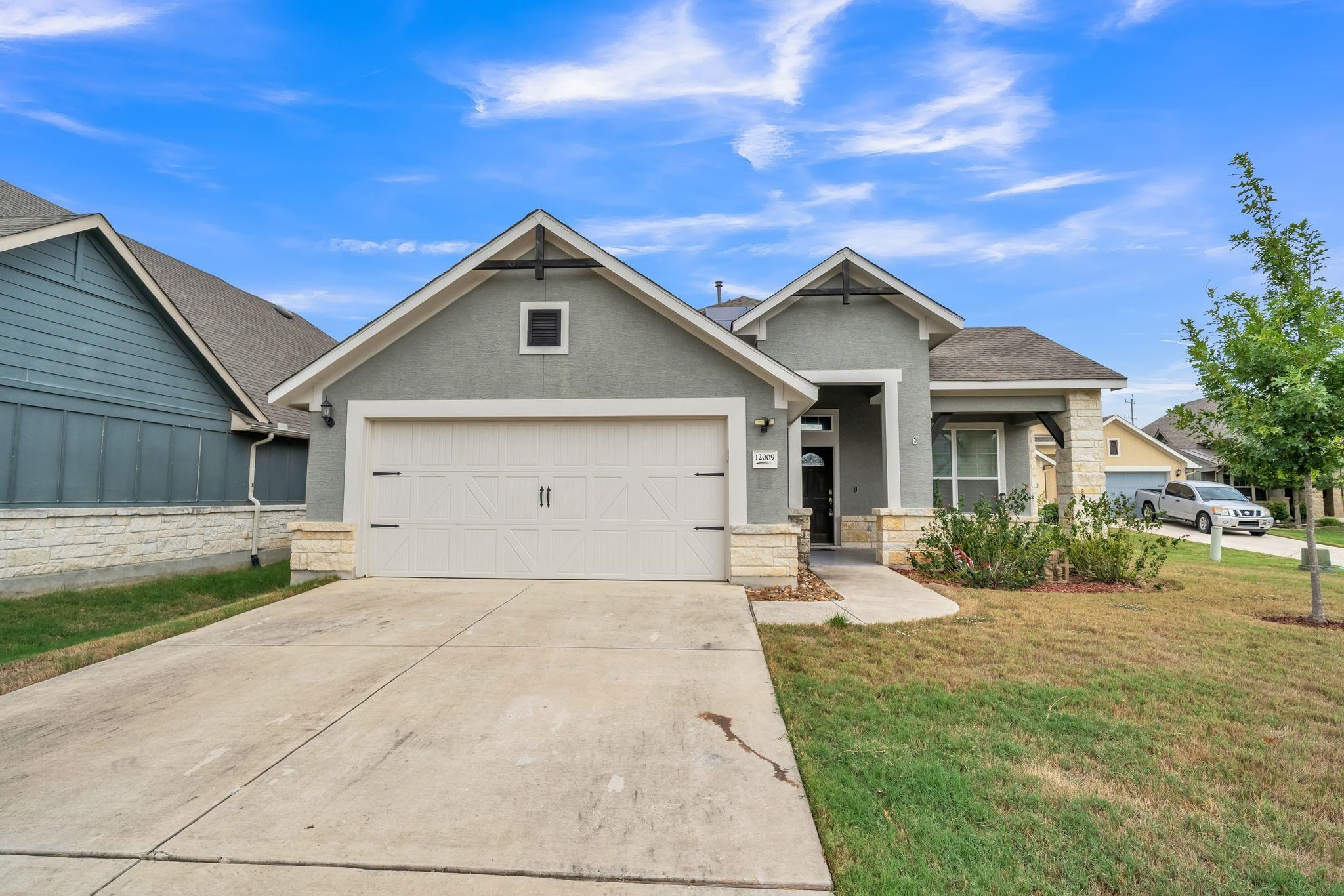 12009 Vignette Schertz, TX 78154 - Photo 1 of 40 a front view of a house with a yard and garage