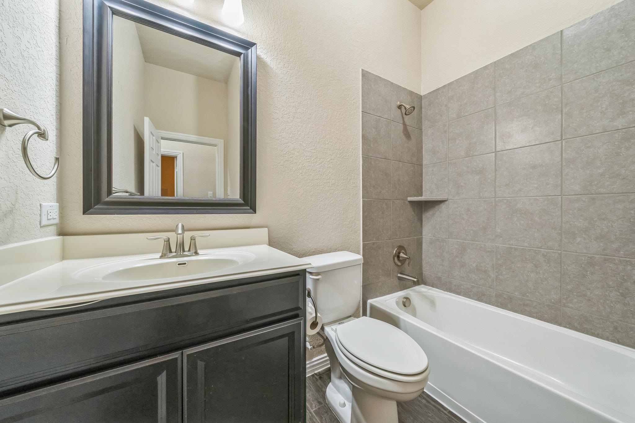 12009 Vignette Schertz, TX 78154 - Photo 25 of 40 a bathroom with a sink a toilet and a mirror