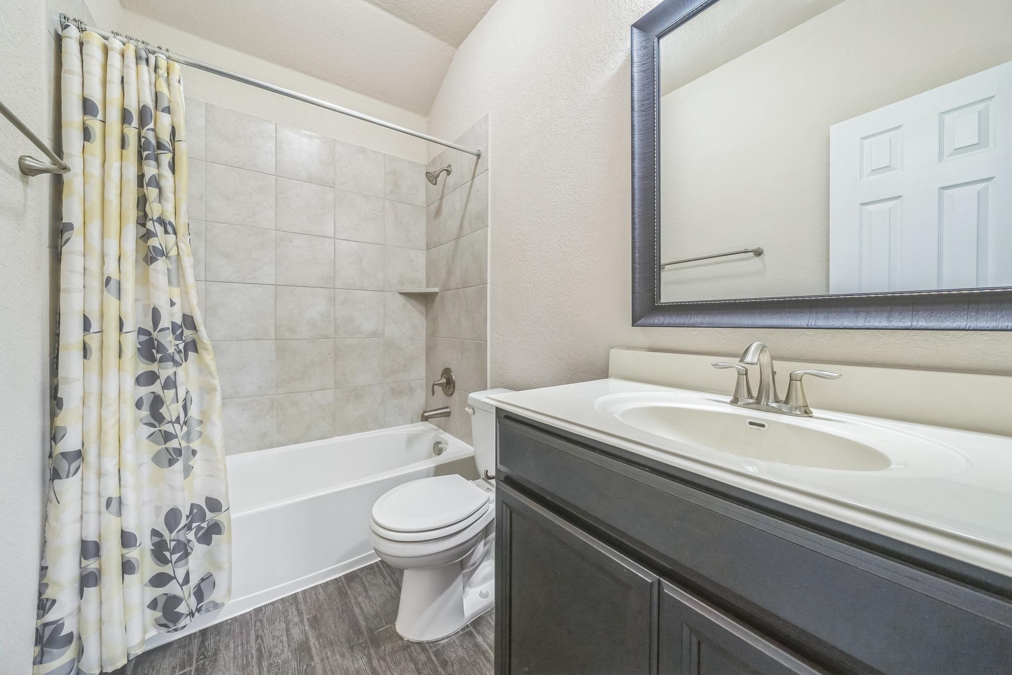 12009 Vignette Schertz, TX 78154 - Photo 32 of 40 a bathroom with a sink a toilet and a bathtub