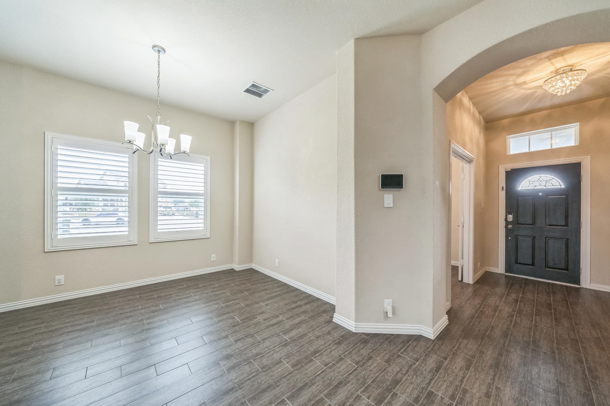 12009 Vignette Schertz, TX 78154 - Photo 6 of 40 an empty room with wooden floor and windows