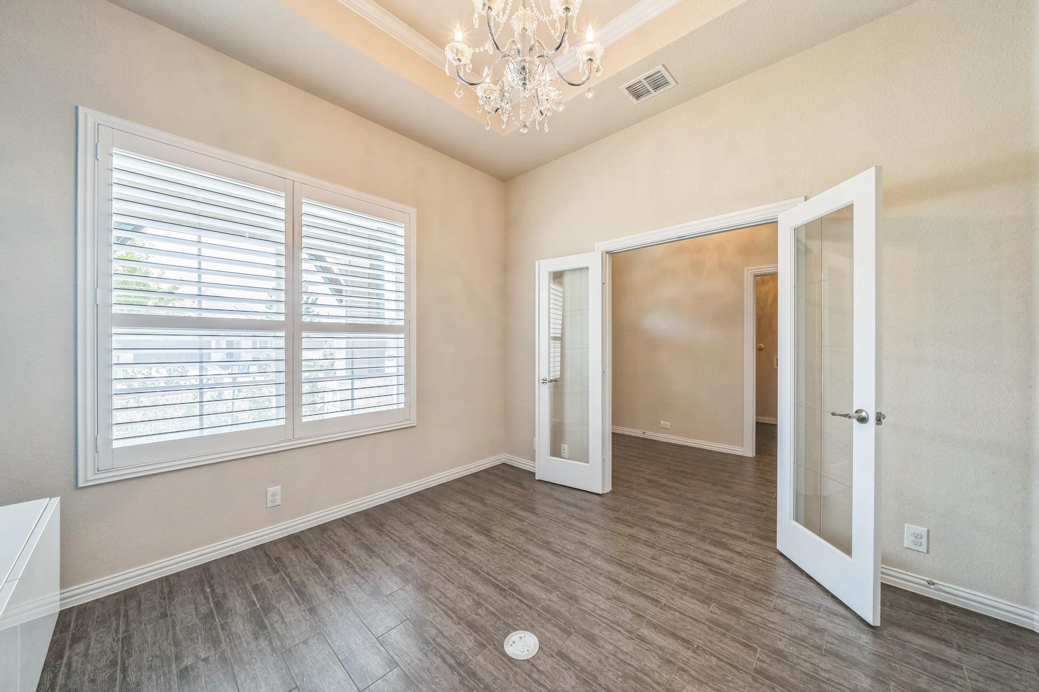 12009 Vignette Schertz, TX 78154 - Photo 8 of 40 a view of an empty room with wooden floor and a window