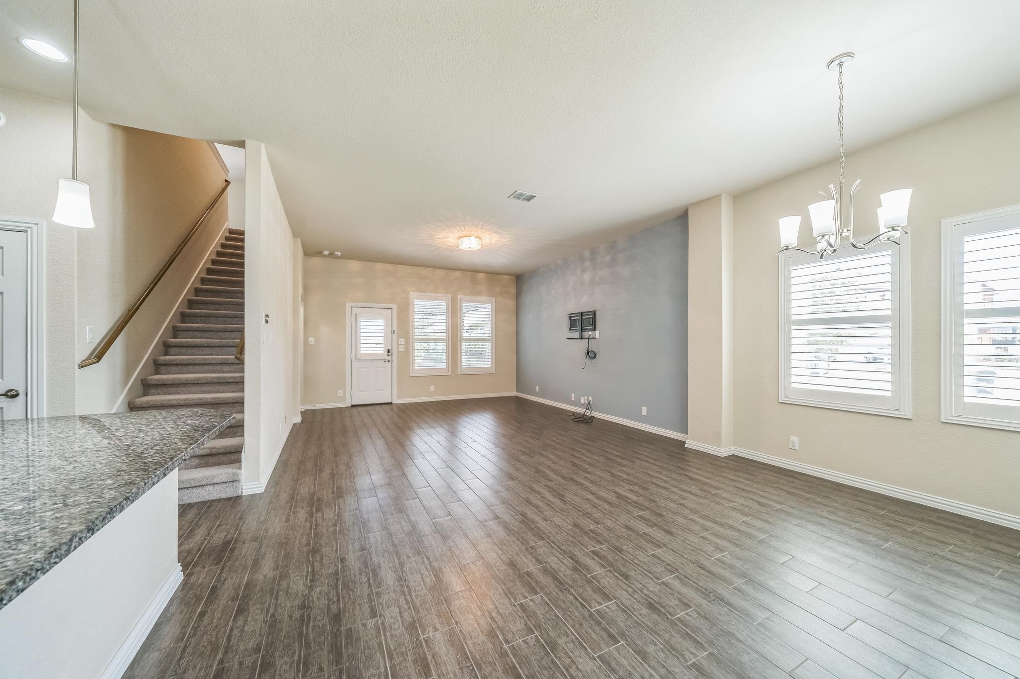 12009 Vignette Schertz, TX 78154 - Photo 9 of 40 an empty room with wooden floor and windows