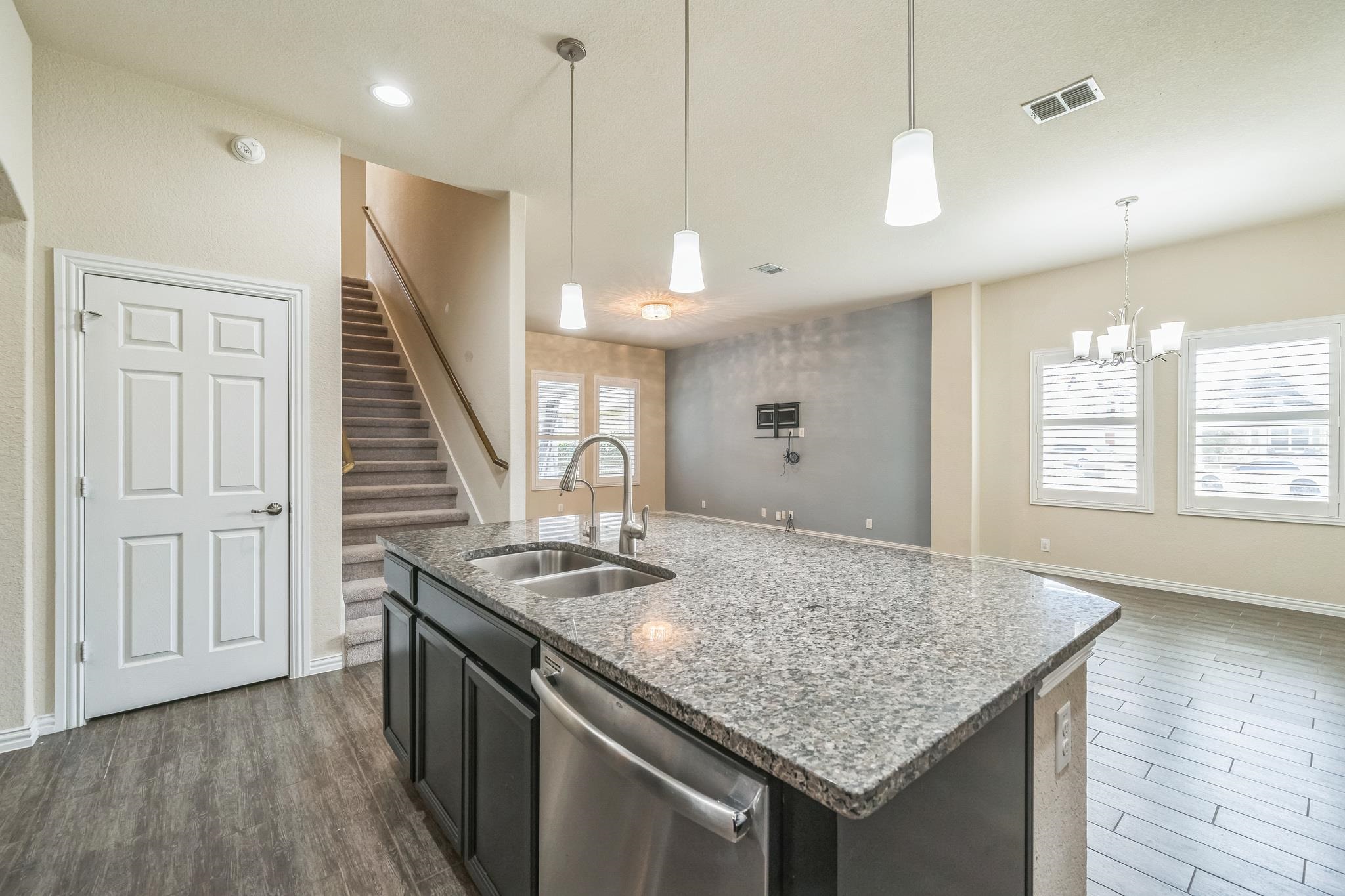 12009 Vignette Schertz, TX 78154 - Photo 10 of 40 a kitchen with stainless steel appliances granite countertop a sink a stove and a wooden floor