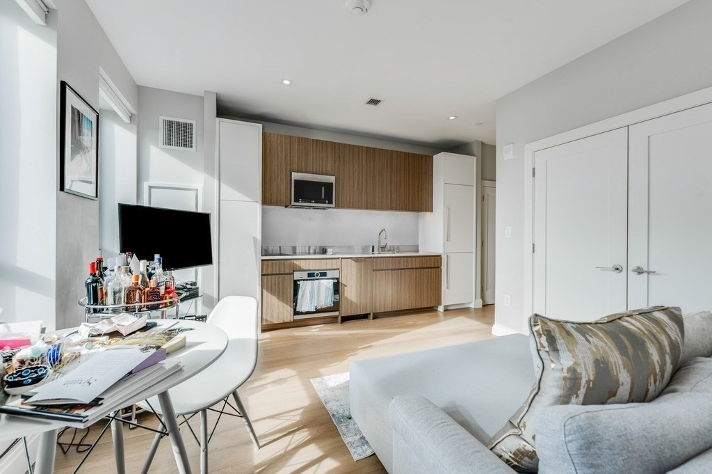 100 Shawmut, Unit 411 Boston, MA 02118 - Photo 1 of 15 a living room with furniture and a flat screen tv