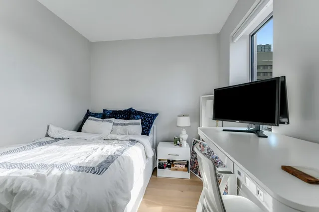 a bedroom with a bed and a flat screen tv