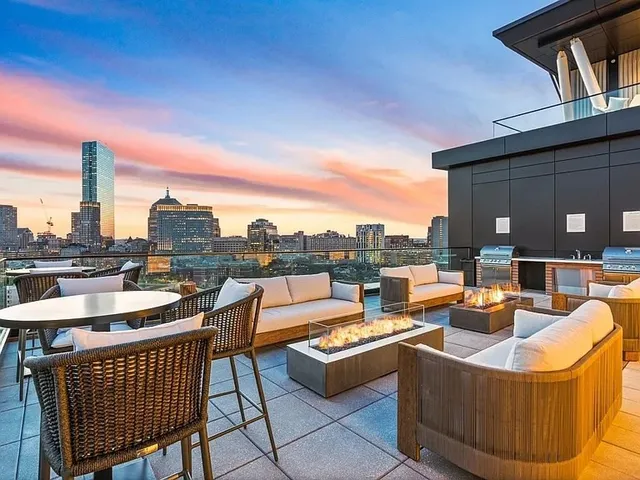 a view of a roof deck with couches and city view