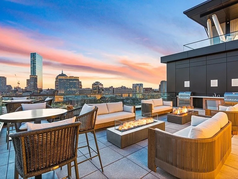 100 Shawmut, Unit 411 Boston, MA 02118 - Photo 15 of 15 a view of a roof deck with couches and city view