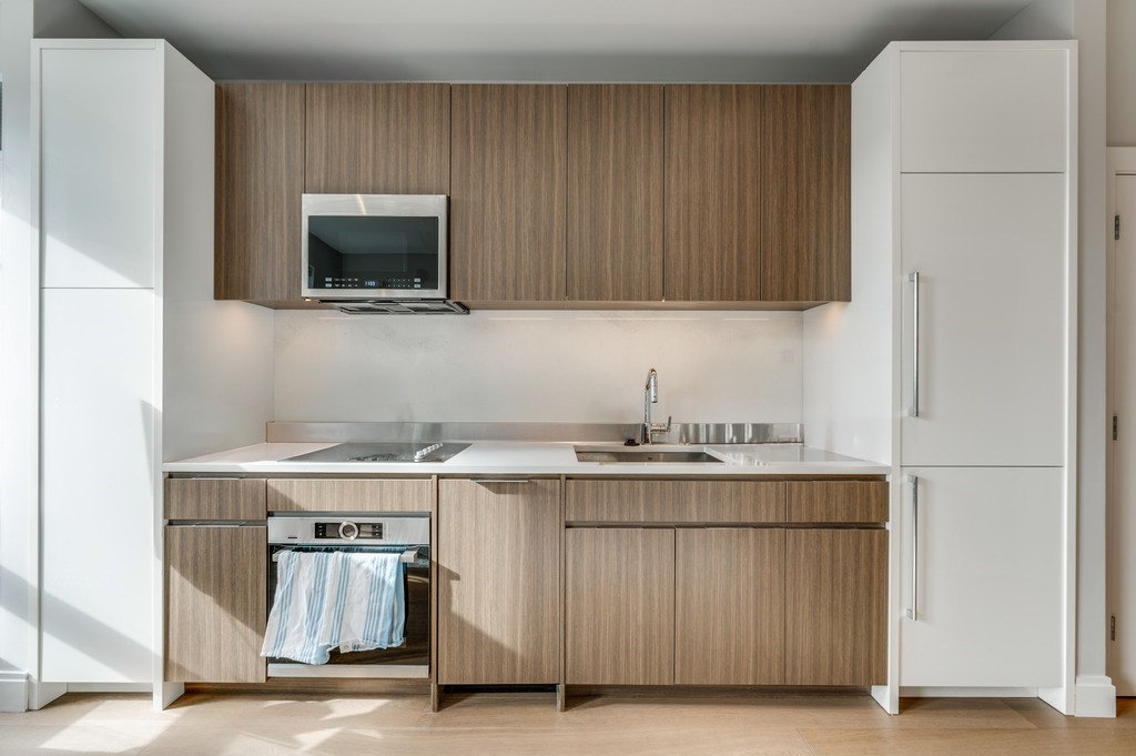 100 Shawmut, Unit 411 Boston, MA 02118 - Photo 4 of 15 a kitchen with a stove and a microwave