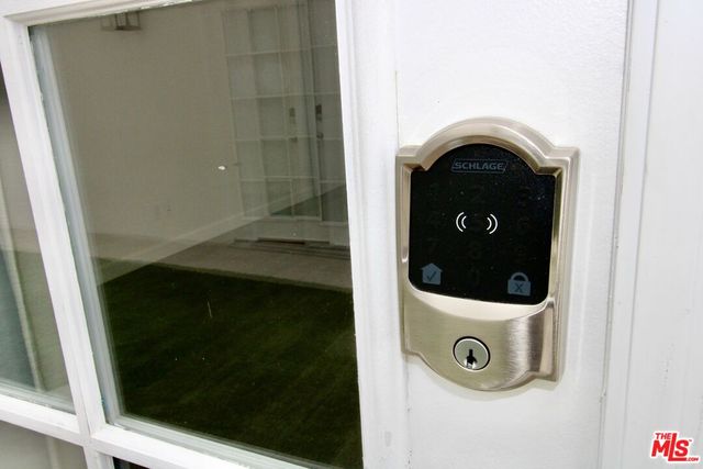 a view of a big room with wooden floor and windows