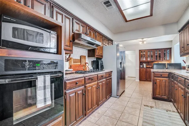 a kitchen with stainless steel appliances granite countertop a stove and a sink