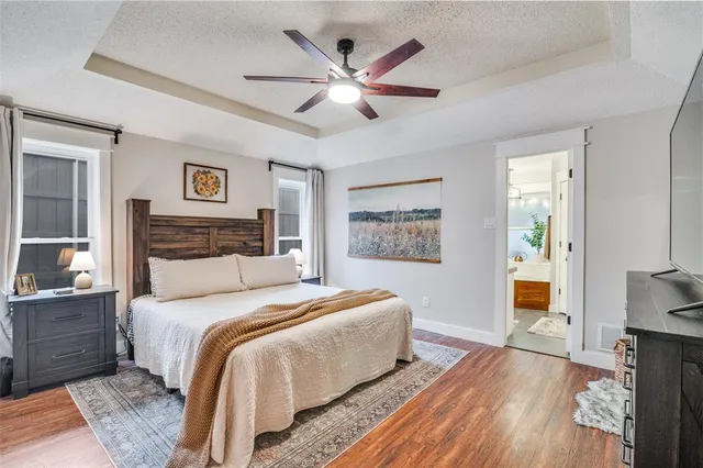 a bedroom with a large bed and a chandelier