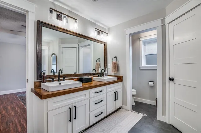 a spacious bathroom with a double vanity sink and a mirror