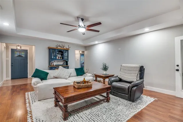 a living room with furniture and a wooden floor